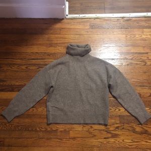 A light brown turtleneck sweater